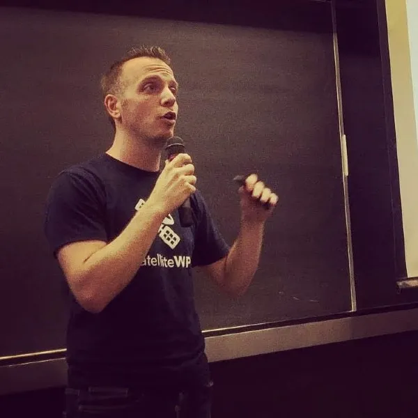 Photo de Maxime Jobin en pleine conférence, micro à la main.